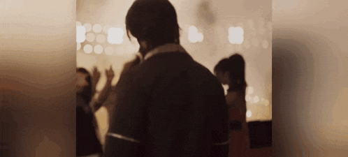 a blurry picture of a man and woman dancing in a room