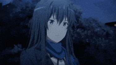 a girl with a scarf around her neck is looking down