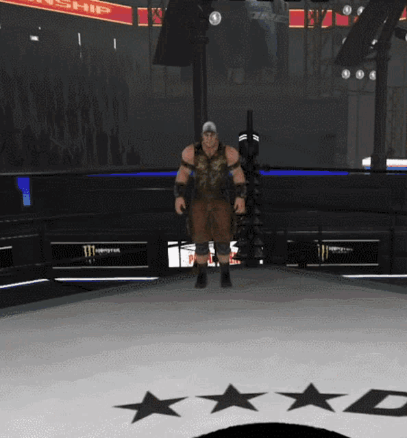 a man stands in a boxing ring with a monster energy sign behind him