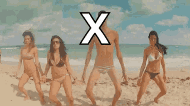 a group of women in bikinis are dancing on a beach with an x in the background