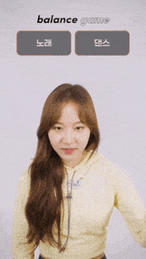 a girl in a yellow hoodie is playing a game called balance game