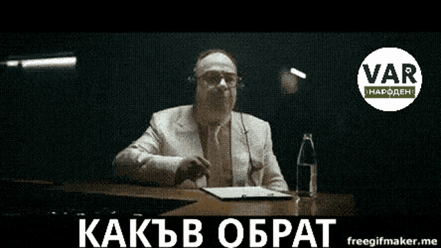 a man wearing headphones is sitting at a table with a sign that says var
