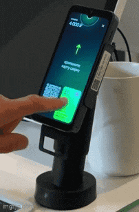 a person is using a smart phone with a qr code on the screen
