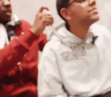 a man in a white hoodie with the word coca cola on the front