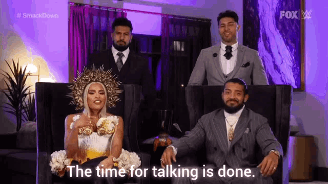a woman in a wedding dress is sitting next to a man in a suit and tie .