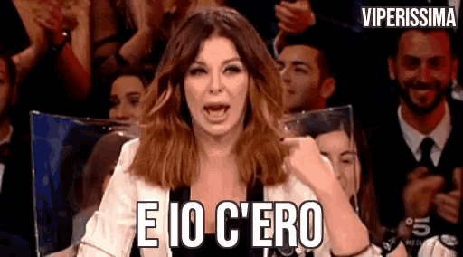 a woman is making a funny face in front of a crowd and says e io c'ero .