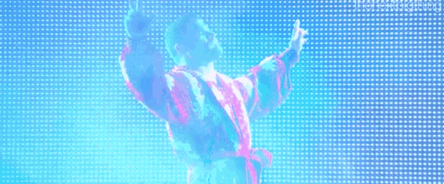 a man in a robe is standing in front of a blue and pink background .