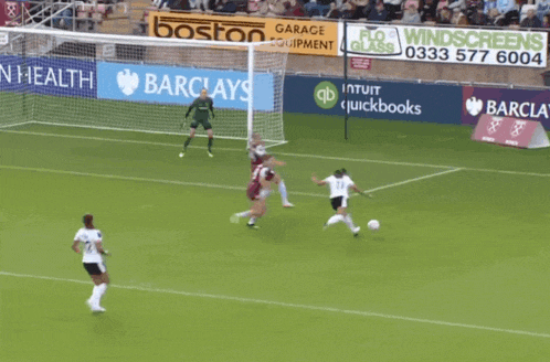 a soccer game is being played in front of a banner for barclay 's
