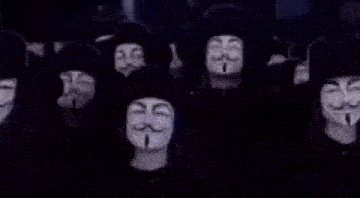 a man wearing a anonymous mask with a mustache and a hat is smiling .