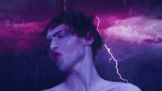 a woman is standing in the rain in front of a purple lightning storm .