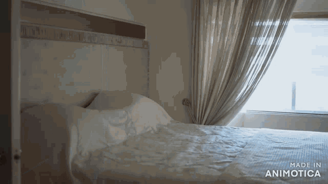 a bed in a room with the words made in animotica on the bottom