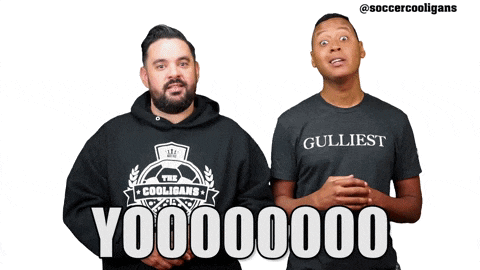 a man wearing a shirt that says gulliest is standing next to another man
