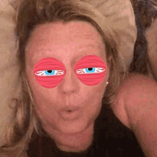 a close up of a woman 's face with cartoon eyes