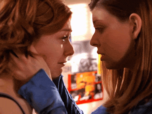 two women are looking at each other and one has a piercing