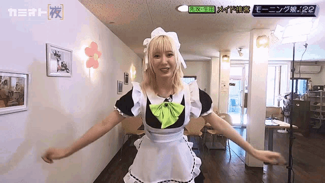 a girl in a maid costume is dancing in a room with a sign that says 122
