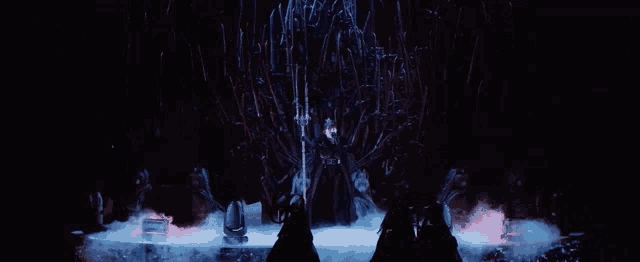 a person standing in front of a throne with a sword in their hand