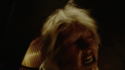 a close up of a person 's face with a very angry expression