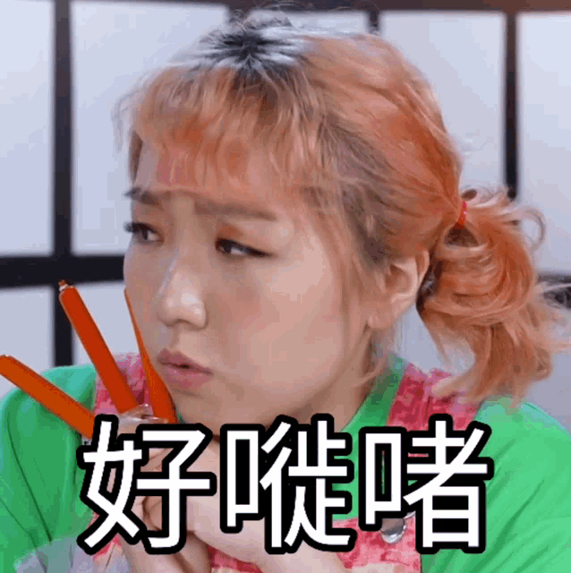 a woman with chinese writing on her face is holding a pair of chopsticks