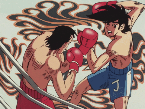 a boxer with the letter j on his shorts is fighting another man