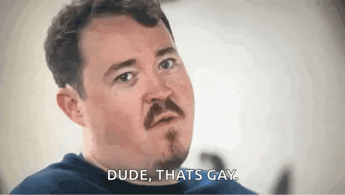 a man with a mustache and beard is talking about being gay .