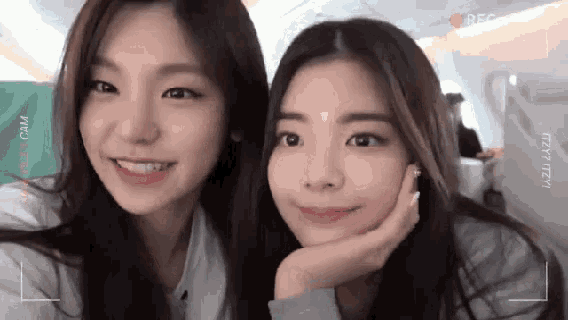 two girls are posing for a picture with a camera that says " recorder " on it