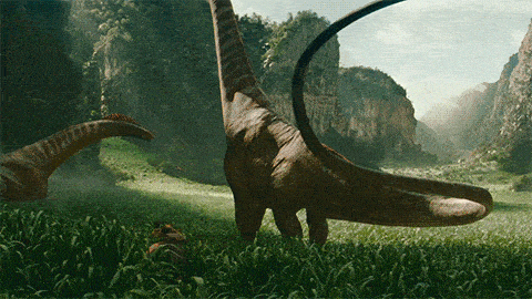 two dinosaurs are standing in a grassy field