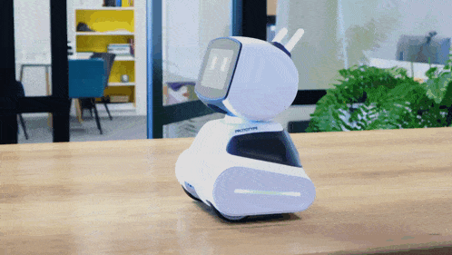 a white and blue prototype robot sits on a table