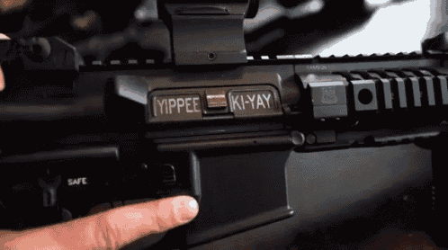 a close up of a rifle with the words yippee ki- yay on the side
