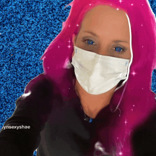a woman with pink hair is wearing a face mask and the name cyni sexyshae is on the bottom right