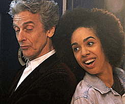 a man and a woman are standing next to each other and the woman is smiling