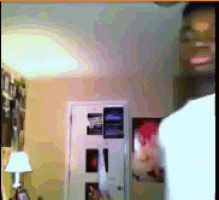 a man in a white shirt is standing in a room