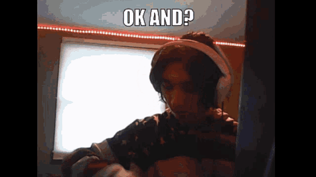 a man wearing headphones says " ok and " in a video