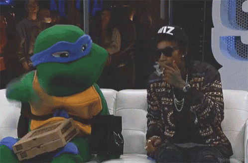 a man in a teenage mutant ninja turtle costume smoking a cigarette