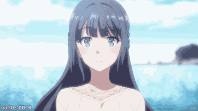 a girl with long black hair is standing in front of the ocean