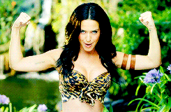 a woman in a leopard print top is flexing her arms
