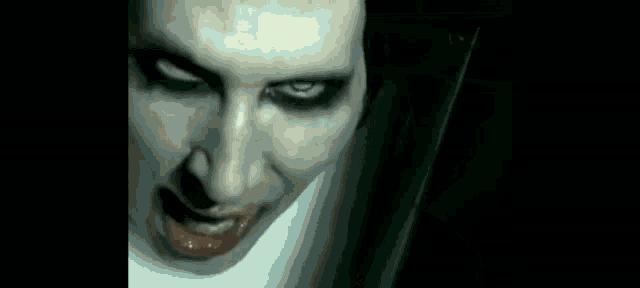 a close up of a woman 's face with glowing eyes and a smile .