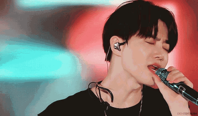 a close up of a man singing into a microphone with the word do on the bottom right
