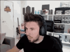 a man wearing headphones is sitting in a room