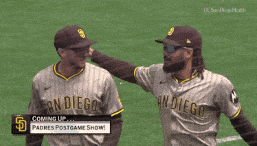 two san diego baseball players standing on the field