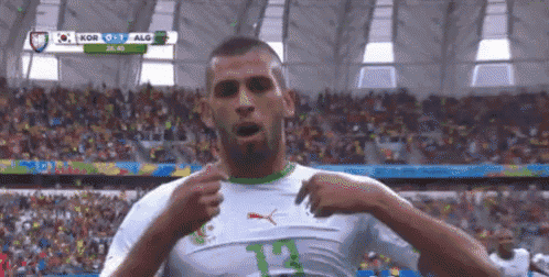 a soccer player wearing a white and green jersey with the number 12 on it