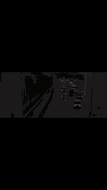 a black background with arabic writing on it and a busy street
