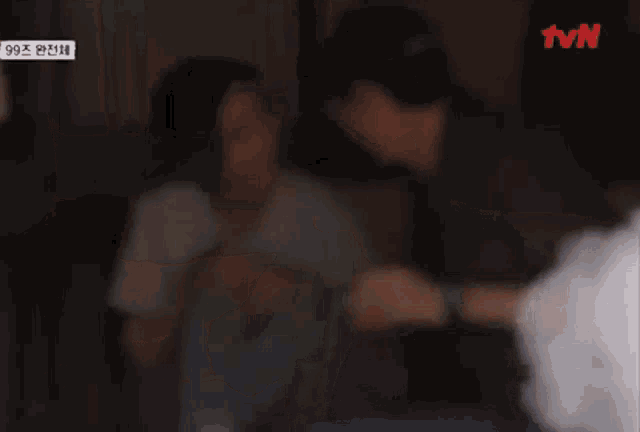 a blurry picture of two women standing next to each other with a tvn logo in the background .