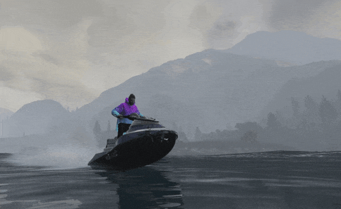 a man in a purple hoodie is riding a jet ski