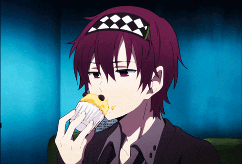 a person with purple hair wearing a checkered headband eating a cupcake