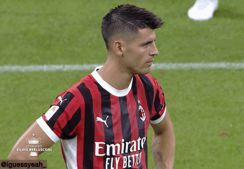 a soccer player wearing a jersey that says emirates fly betz