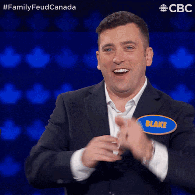 a man in a suit and a name tag that says blake