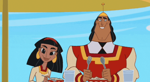 a man and a woman are sitting at a table eating