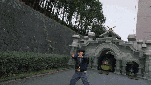 a man is standing in front of a castle with a sign that says ' mc ' on it