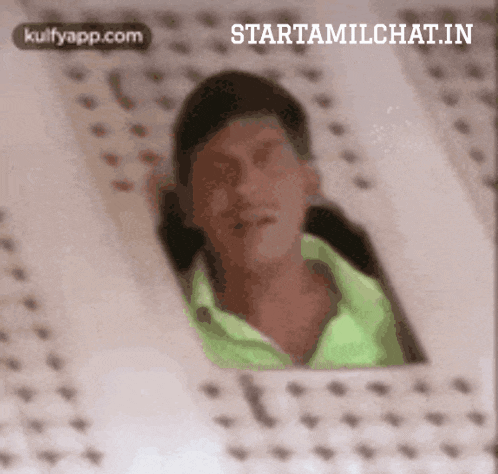 a man in a green shirt is looking out a window with the words starttamilchat.in written on the bottom