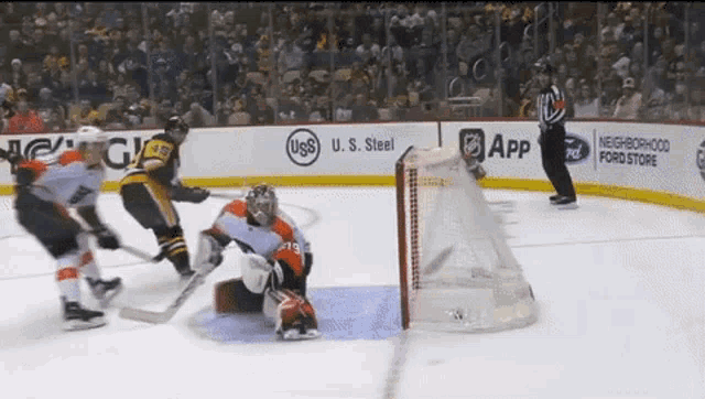 a hockey game is being played in front of a ford store advertisement